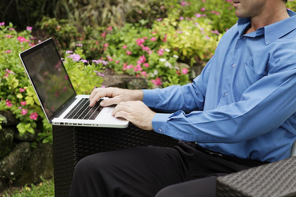 Crystalbrook Riley Cairns Exterior foto A man working on a laptop